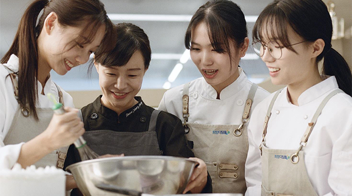 Young adults and an instructor participating in a Samsung Stepping Stone of Hope job training session.